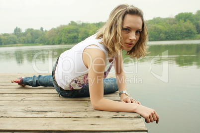 girl in blue jeans near water