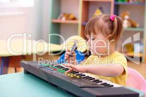 Girl with electronic piano and microphone