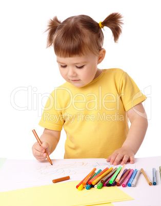 Cute child draws with felt-tip pens