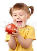 Cute child is going to bite an apple