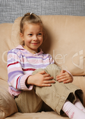 Happy child in armchair.