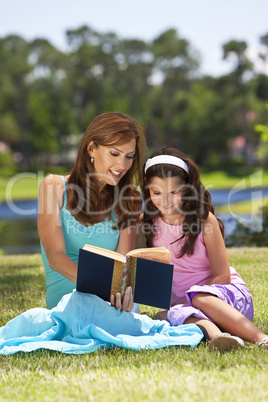 Woman and Girl, Mother and Daughter, Reading a Book Together Out