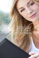 Beautiful Young Blond Woman Reading Folder or Menu