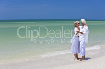 Happy Senior Couple Dancing Holding Hands on Tropical Beach