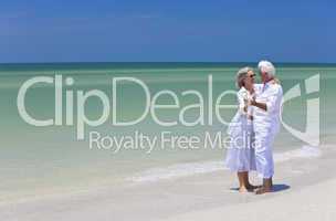 Happy Senior Couple Dancing Holding Hands on Tropical Beach