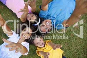 Father Mother Son and Daughter Family Laying Down Hands Up