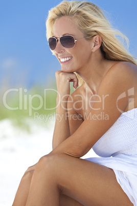 Beautiful Blond Woman in White Dress and Sunglasses At Beach