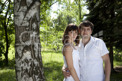 Woman and man posing in the middle of nature