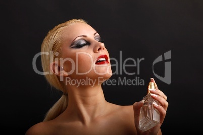 beautiful young woman with perfume flacon