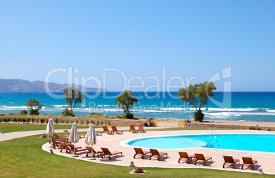 Swimming pool by beautiful beach and turquoise sea, Crete, Greec