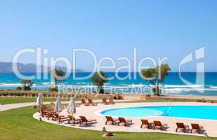 Swimming pool by beautiful beach and turquoise sea, Crete, Greec