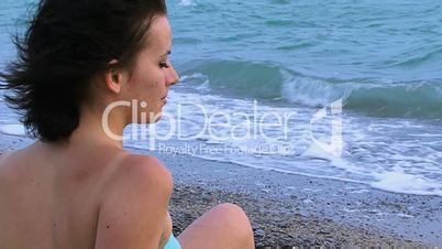 Girl sits on the sea