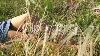 Girl is resting in the meadow
