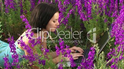 Girl on the nature of the laptop
