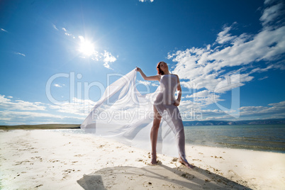 woman in white on coast of sea