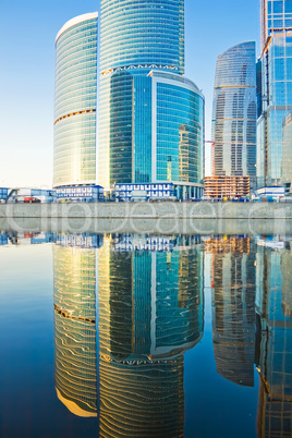 Business skyscrapers and reflections in the river