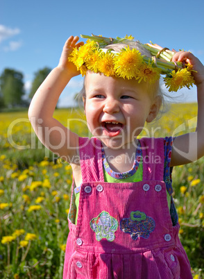 happy girl with dandelion wreath