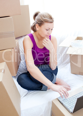 Beautiful woman using a laptop in the living-room