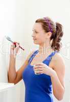 Beautiful woman is decorating a room