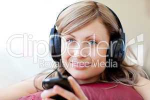 Relaxed woman is listening the music in the living-room