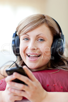Happy woman is listening the music in the living-room