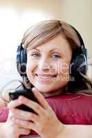 Delighted woman is listening the music in the living-room