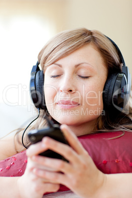 Radiant woman is listening the music in the living-room