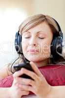 Radiant woman is listening the music in the living-room