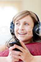 Caucasian woman is listening the music in the living-room