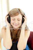 Cute woman is listening the music in the living-room