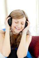 Beautiful woman is listening the music in the living-room