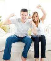 Charming couple punching the air