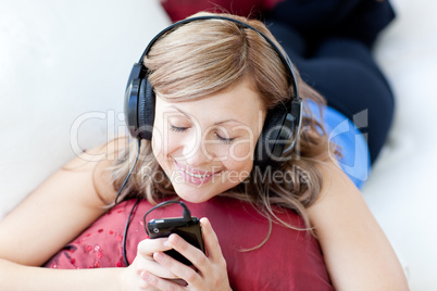 Joyful woman is listening the music in the living-room