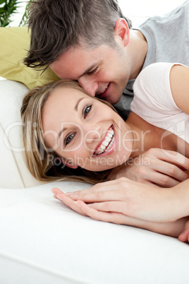 Young lovers having fun together on a sofa