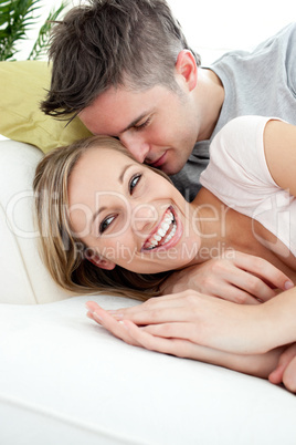 Happy lovers having fun together on a sofa