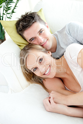 Beautiful lovers having fun together on a sofa