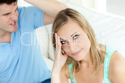 Stressed couple having an argue in the living-room