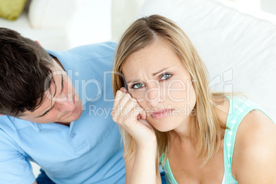 Sad couple having an argue in the living-room