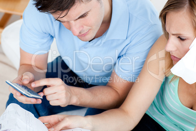 Cute couple using a remote in the living-room