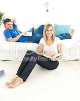 United couple reading book in the living-room