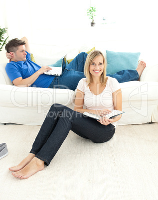 Cute couple reading book in the living-room