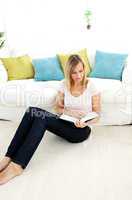 Beautiful woman reading a book in the living-room