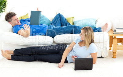 Smiling couple having fun together in the living-room