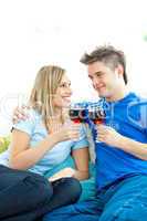 Beautiful couple drinking wine together in the living-room