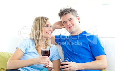 Cute couple drinking wine together in the living-room