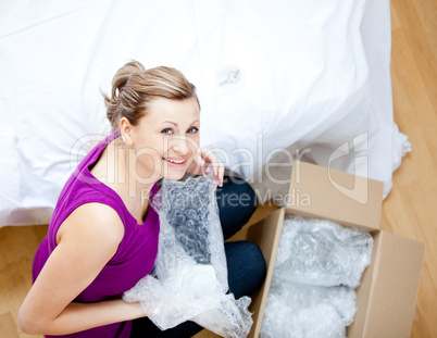 Delighted woman having a break between boxes