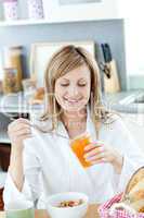 Cute woman having a breakfast in the kitchen