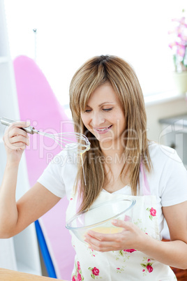 Delighted woman preparing a meal in the kitchen