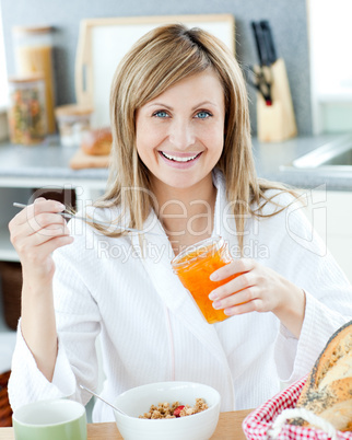 Young woman having breakfast in the kitchen