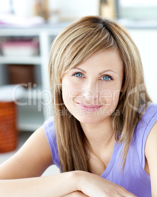 Delighted woman looking at the camera in the kitchen